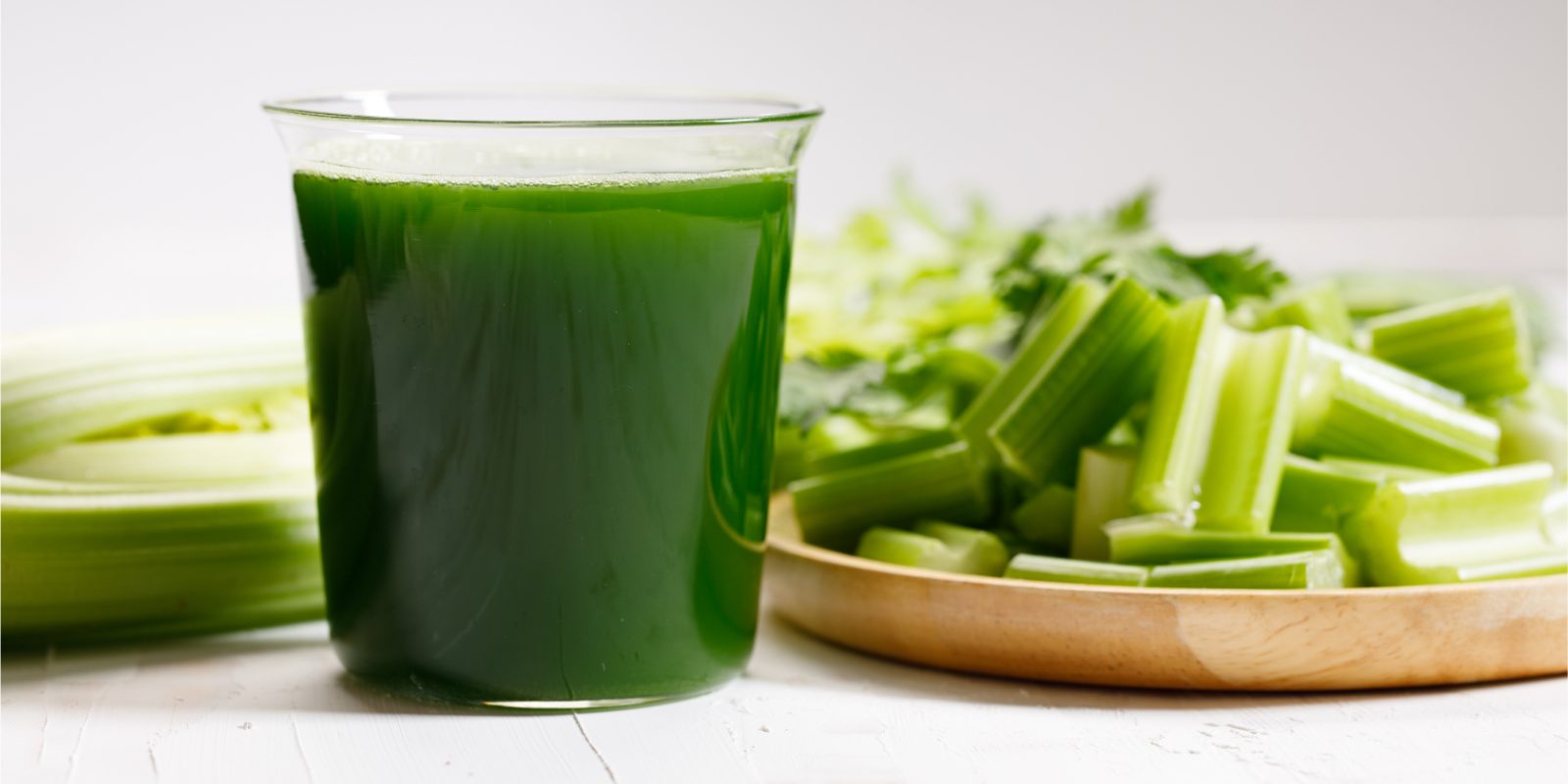 Benefits of Juicing featuring a glass of green vegetable juice