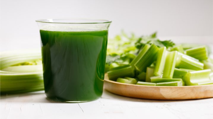 Benefits of Juicing featuring a glass of green vegetable juice